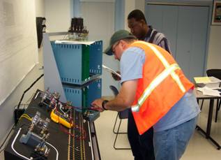 Students Working Near Track Trainer