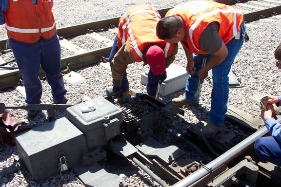 Men Working With a Switch Machine in the Field
